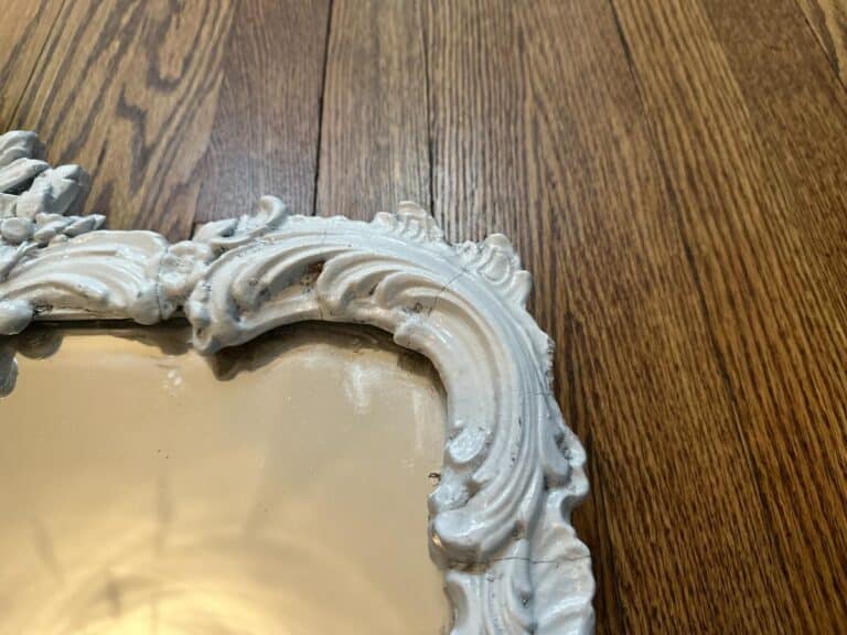Vintage Chinoiserie Mirror with intricate designs on a white, ornate wooden frame.