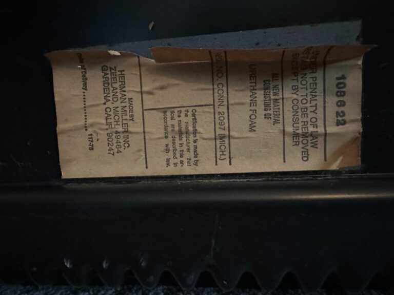 Close-up of a Herman Miller Blue Sectional label, detailing manufacturing and material information.