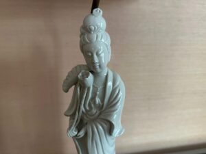The Blanc De Chine Figural Lamps, Pair, feature serene porcelain statues with flowing robes, intricate headdresses, and figures holding lotus flowers.