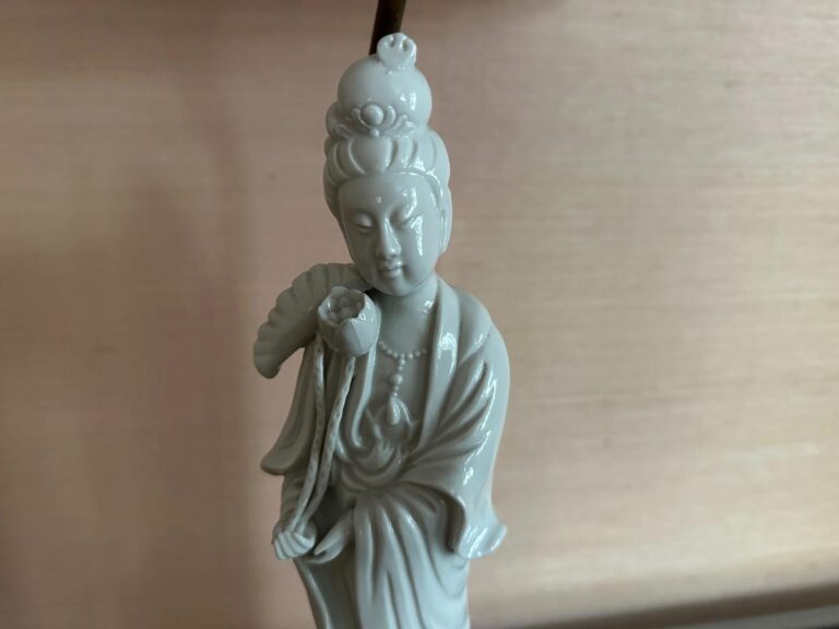 The Blanc De Chine Figural Lamps, Pair, feature serene porcelain statues with flowing robes, intricate headdresses, and figures holding lotus flowers.