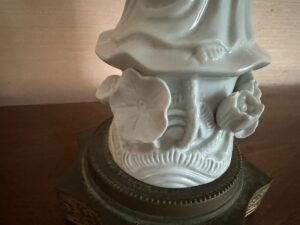Pair of Blanc De Chine Figural Lamps on a wooden surface, showcasing floral designs and intricate carvings.