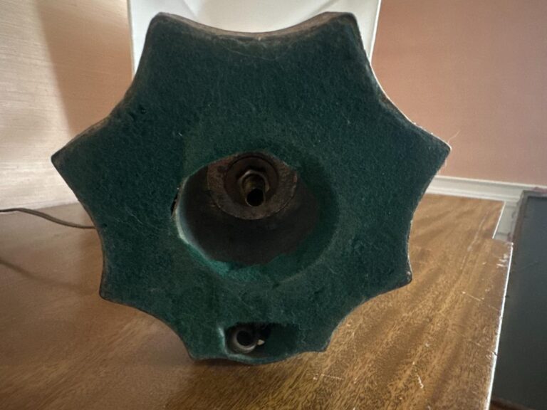 Pair of Blanc De Chine Figural Lamps with green felt hexagonal bases resting on a wooden surface.