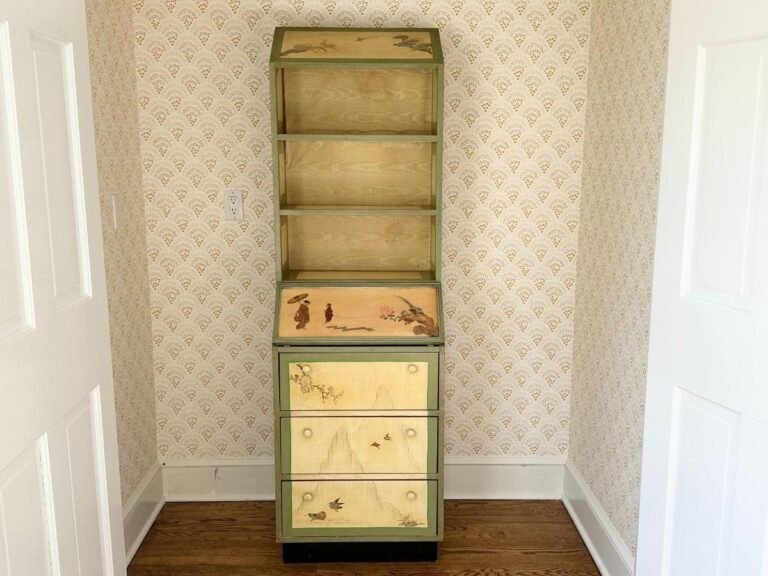 A tall, vintage Hand Painted Secretary Desk with Bookcase showcases nature scenes, set against patterned wallpaper on a wooden floor.