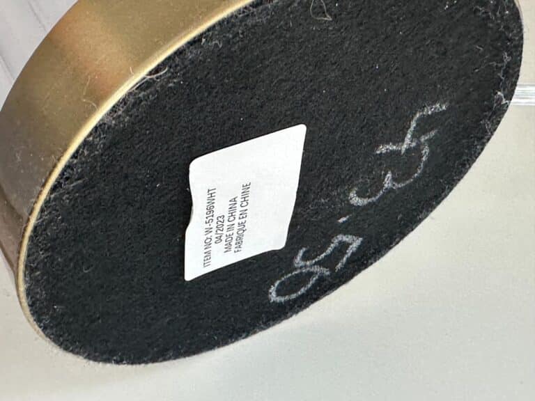 A round object with a black surface, a white label, and “43.50” written in white marker.